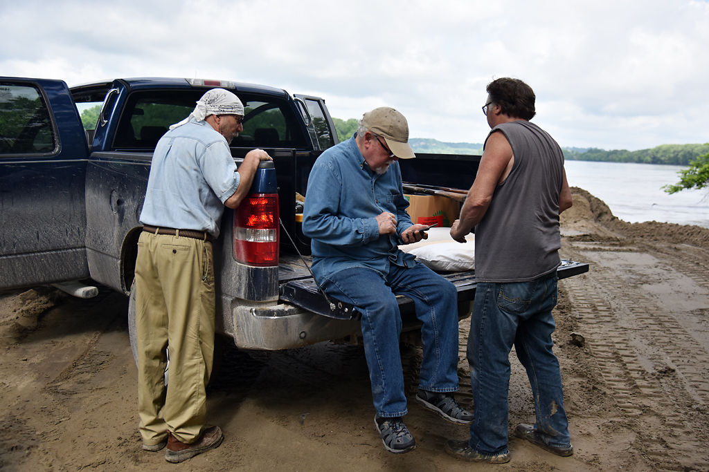 Jonathan Lauten, Mike Robertson and Mike Cooper pause after moving items